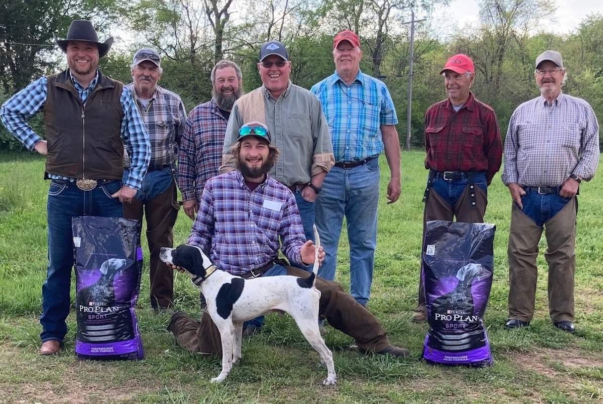 In foreground is Taylor Henley (scout) with One Day Frost, third place Amateur Shooting Dog Stake winner. Standing, from left: Lane Hodges, Jimmy Gentry, Ronnie Rogers, Ross Leonard, Judges Ron Lambert and Jim Crayne, and Arnold Hall