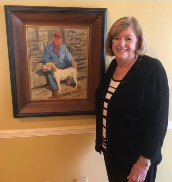 Nancy Mock with painting of Tommy Mock