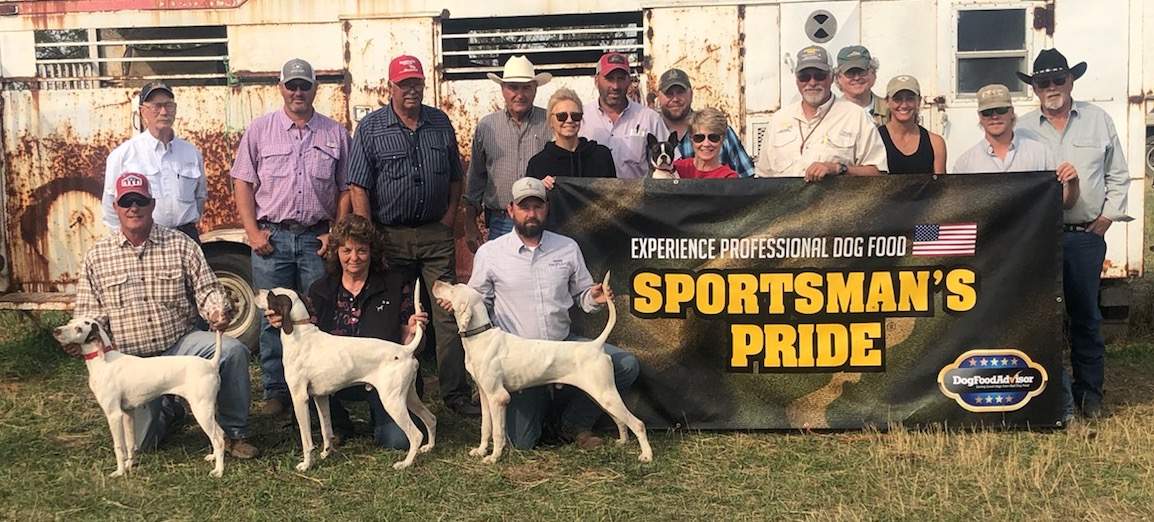 North Dakota Classic Winners. Foreground, from left: Mark Haynes with Sadie Firefly, Sharlene Daugherty with Dream Chaser, and Judd Carlton with Touch's Red Rider. Second row (behind banner): Lori Vincent, Marion Mills, Allen Vincent, April Coffin, a