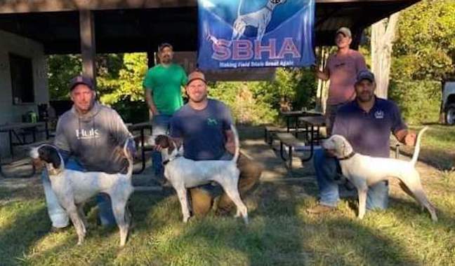 Open Shooting Dog Winners. From left:. Ravenwood Throwing Smoke with Matt Basilone, Bad Bourbon with Gunner Boyer and Great River Dan with Marcus Ramseur. Behind: Judges Andy Bogar and Jameson Crandall.